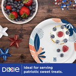 Dixie floral paper plate on a wooden table with a small dessert and decorative stars nearby