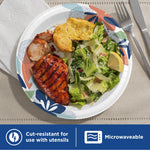 Dixie paper plate filled with grilled chicken, salad and a biscuit, highlighting decorative rim and microwavable feature.