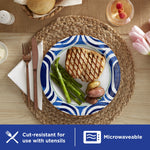 Dixie Ultra 10" blue-swirl paper plate on woven placemat with grilled meat, asparagus and potatoes