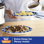 Person holding a Dixie Ultra DeepDish blue rim paper plate filled with pasta while another plate with food sits on a table