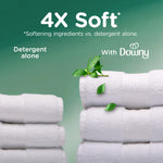 Stacked white towels with text comparing detergent alone vs with Downy and 4X Soft claim