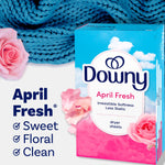 Downy April Fresh dryer sheets box beside pink roses and a blue knitted fabric, product benefits listed at left