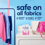 downy april fresh dryer sheets box on a dryer beside a laundry basket and hanging clothes, with wall text in the background