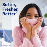 Person holding a pink sweater to their face with text promoting softer, fresher results for Downy April Fresh dryer sheets