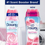 Comparison graphic showing old and new Downy April Fresh scent booster packaging side by side with floral visuals