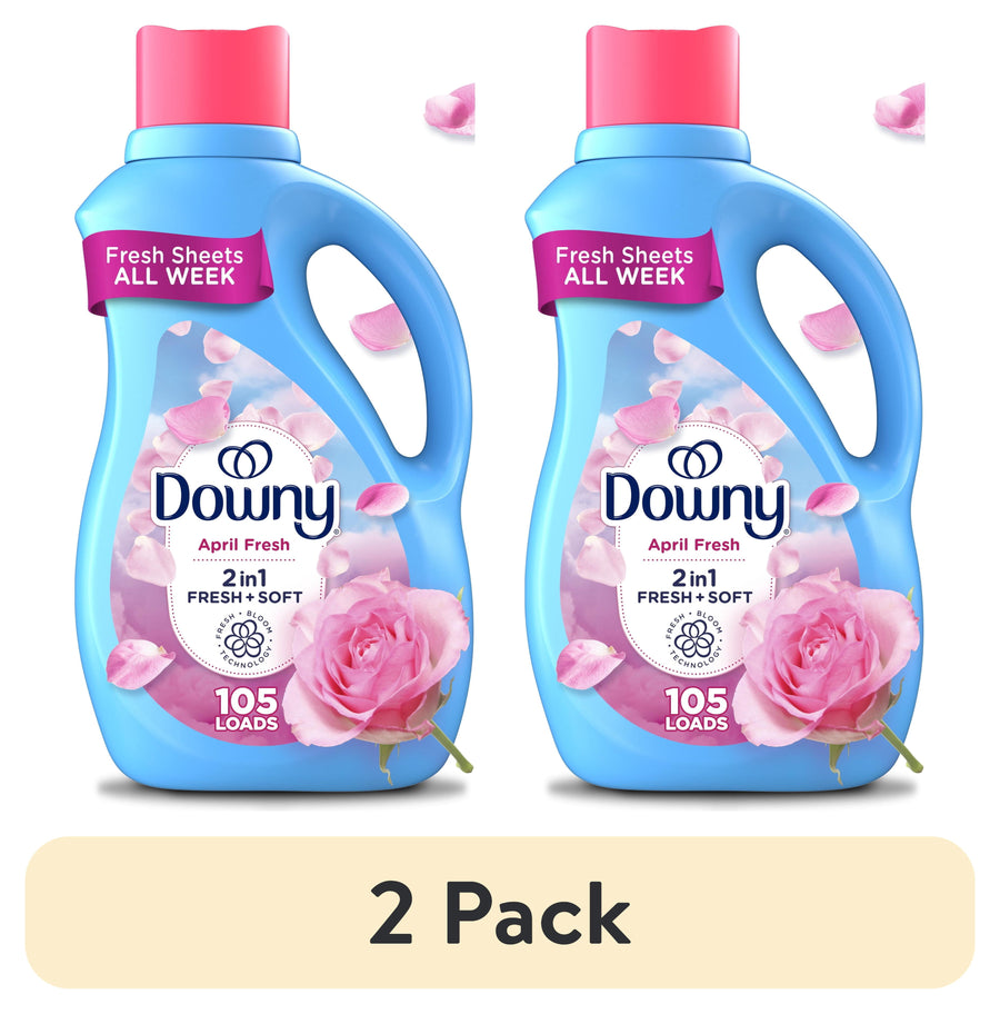 Two blue Downy April Fresh liquid fabric softener bottles side-by-side with pink rose and petals
