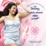 Woman reclining on pink petals with Downy logo and text promoting 'Fresh sheet week' and blossom graphic