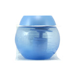 Studio product photo of a translucent blue Downy Ball in clear blister packaging shown on white background.