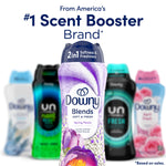 Promotional image showing Downy Blends Spring Peony bottle in front of blurred competing scent booster bottles
