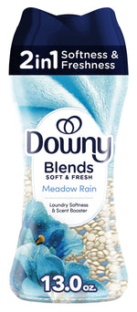 Tall bottle of Downy Blends Soft & Fresh Meadow Rain scent booster with blue floral graphics and visible white and blue beads