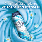 Downy Blends Meadow Rain bottle set on a swirling blue fabric background with small blue flowers and promotional headline