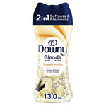 Downy Blends toasted vanilla in-wash scent booster bottle with vanilla flowers and 13.0 oz label on white background.