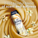 Downy Blends toasted vanilla bottle set against a swirled vanilla background with vanilla flowers and promotional 2-in-1 text.