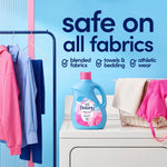 Downy bottle displayed on a dryer with hanging garments and text stating 'safe on all fabrics'.