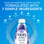 Downy bottle centered with water ring and icons above stating formulation with seven simple ingredients on blue background