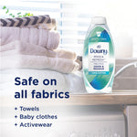 Downy Rinse & Refresh Cool Cotton bottle staged on a countertop next to folded towels with text saying safe on all fabrics.