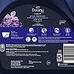 Close-up of the back label of a Downy Calm fabric softener bottle showing usage icons, text and a barcode.
