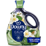 Close-up of a Downy Fresh Calm liquid fabric softener bottle with white floral graphics and green accents.