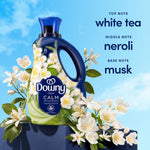 Downy Calm bottle staged with white blossoms and text listing fragrance notes: white tea, neroli, musk