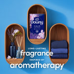 Downy CALM box placed in wooden wall niches with folded towels and diffuser, 'long-lasting fragrance' text
