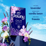 Downy CALM box displayed with flowers and notes listing 'lavender, vanilla bean, freesia' against a blue sky background.