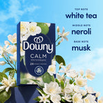 Downy CALM product box staged with white blossoms and text listing top, middle and base fragrance notes