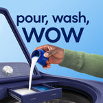 Close-up showing liquid being poured from a measuring cap into a washing machine dispenser with 'pour, wash, wow' text.