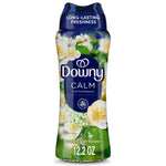 Tall bottle of Downy Calm laundry scent booster with floral graphics and visible green scent beads