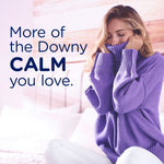 Woman in a purple sweater cuddling fabric next to text reading “More of the Downy CALM you love.”