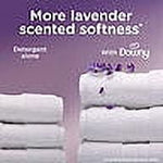 Side-by-side fabric stacks comparing scent and softness with a Downy Calm bottle illustrated above on a lavender background.
