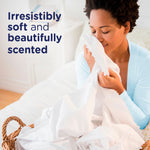 Person smelling a white sheet with text 'Irresistibly soft and beautifully scented' for Downy Cool Cotton