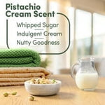 Infographic panel showing pistachio cream scent notes with bowls, milk jug, and stacked towels listing whipped sugar, indulgent cream, nutty goodness