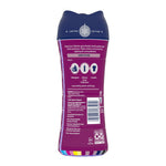 Rear view of purple Downy Cozy Collection Snow Berry scent booster bottle showing usage icons, barcode and product information