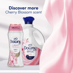 Downy Light Cherry Blossom bottle beside a Downy Gentle detergent jug with flowing pink fabric and headline 'Discover more'.