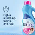 Partial bottle of Ultra Downy April Fresh at right with text 'Fights stretching, fading, and fuzz' on blue background