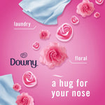 Pink promotional graphic with Downy logo, roses and text describing floral laundry scent for Febreze product