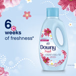 Downy Fresh bottle on a soft blue background with floral accents and large text reading “6 weeks of freshness.”