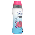 Angled view of Downy Fresh Protect bottle with pink cap and decorative dot graphics over blue gradient