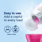 Instructional image showing pink scent beads pouring from a Downy Fresh Protect bottle into a pink cap with usage icons