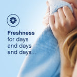 Close-up lifestyle image of someone smelling a soft blue textured fabric with text 'Freshness for days and days and days…'