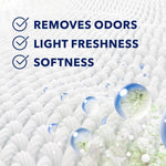 Close-up textured white fabric background with droplets and text listing removes odors, light freshness, softness