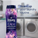 Single Downy Infusions Calm bottle with laundry room background and text 'Scent up your laundry routine'.
