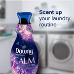 Downy Infusions Calm bottle in a laundry room scene with text ‘Scent up your laundry routine’