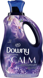 Close-up of a purple Downy Infusions Calm fabric softener bottle with floral graphics and handle