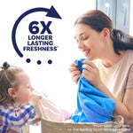 Smiling woman and child smelling laundry with a 6x longer lasting freshness graphic