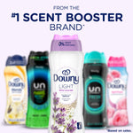 Centered Downy Light White Lavender bottle with blurred lineup of other scent booster bottles and headline claim