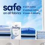 Downy Light Ocean Mist box displayed between neatly folded blue and white laundry with text saying safe on all fabrics