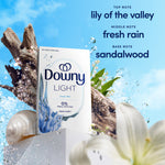 Product box of Downy Light Ocean Mist shown with wood, shells and floral elements and fragrance note text