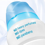 Close-up of Downy Light bottle cap and label text listing 'NO heavy perfumes NO dyes NO parabens'
