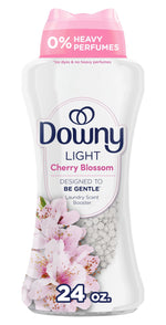 Close-up of a Downy Light Cherry Blossom scent booster bottle showing label, blossoms and white beads.
